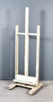 A 19th Century Cream Painted Pine Artist's Easel, on square uprights and trestle feet, 23ins x 21ins