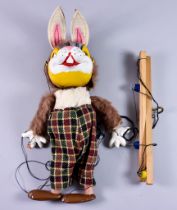 A Rabbit Pelham Puppet, Circa 1960, with felt ears and checked trousers, puppet 12ins overall, in