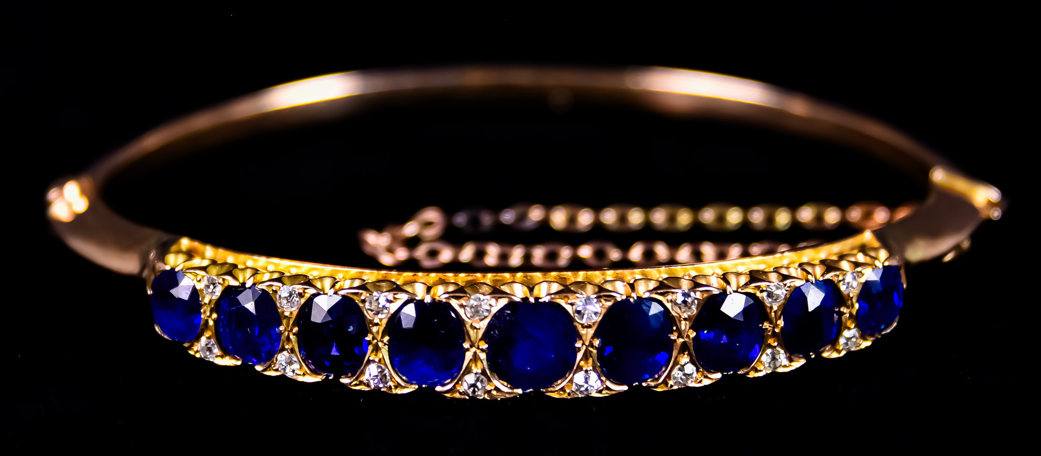 A 14ct Gold Sapphire and Diamond Bracelet, set with nine natural basaltic sapphires, approximately