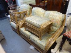 A BAMBOO AND CANE CONSERVATORY SUITE WITH LOOSE CUSHIONS, VIZ A TWO SEATER SETTEE, AN ARMCHAIR, AN