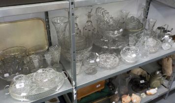 A LARGE SELECTION OF MOULDED AND CUT GLASS WARES TO INCLUDE; DECANTERS, BOWLS, VASES, CANDLESTICK