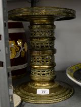 AN AGED EASTERN HEAVY CAST BRASS CANDLE HOLDER IN TWO INTERLOCKING SECTIONS with openwork stem and