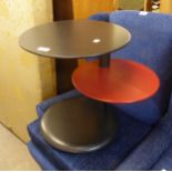 A BLACK AND RED FINISH CIRCULAR TWO TIER OFFSET COFFEE TABLE ON BLACK CIRCULAR PLATFORM BASE