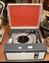 A RETRO PORTABLE RECORD PLAYER IN CARRY CASE