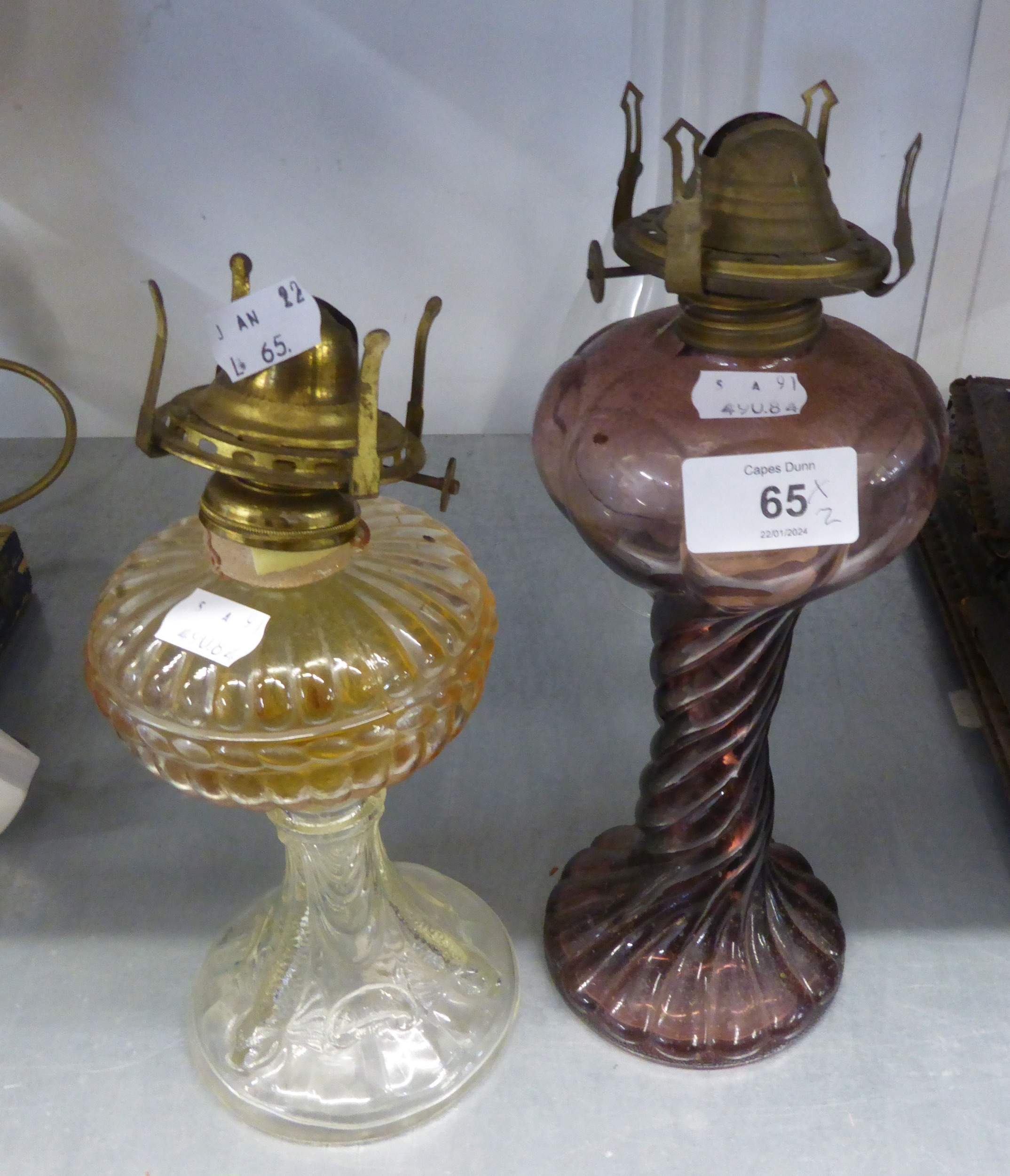 TWO SPIRALLY FLUTED GLASS OIL TABLE LAMPS AND THE GLASS FINIALS