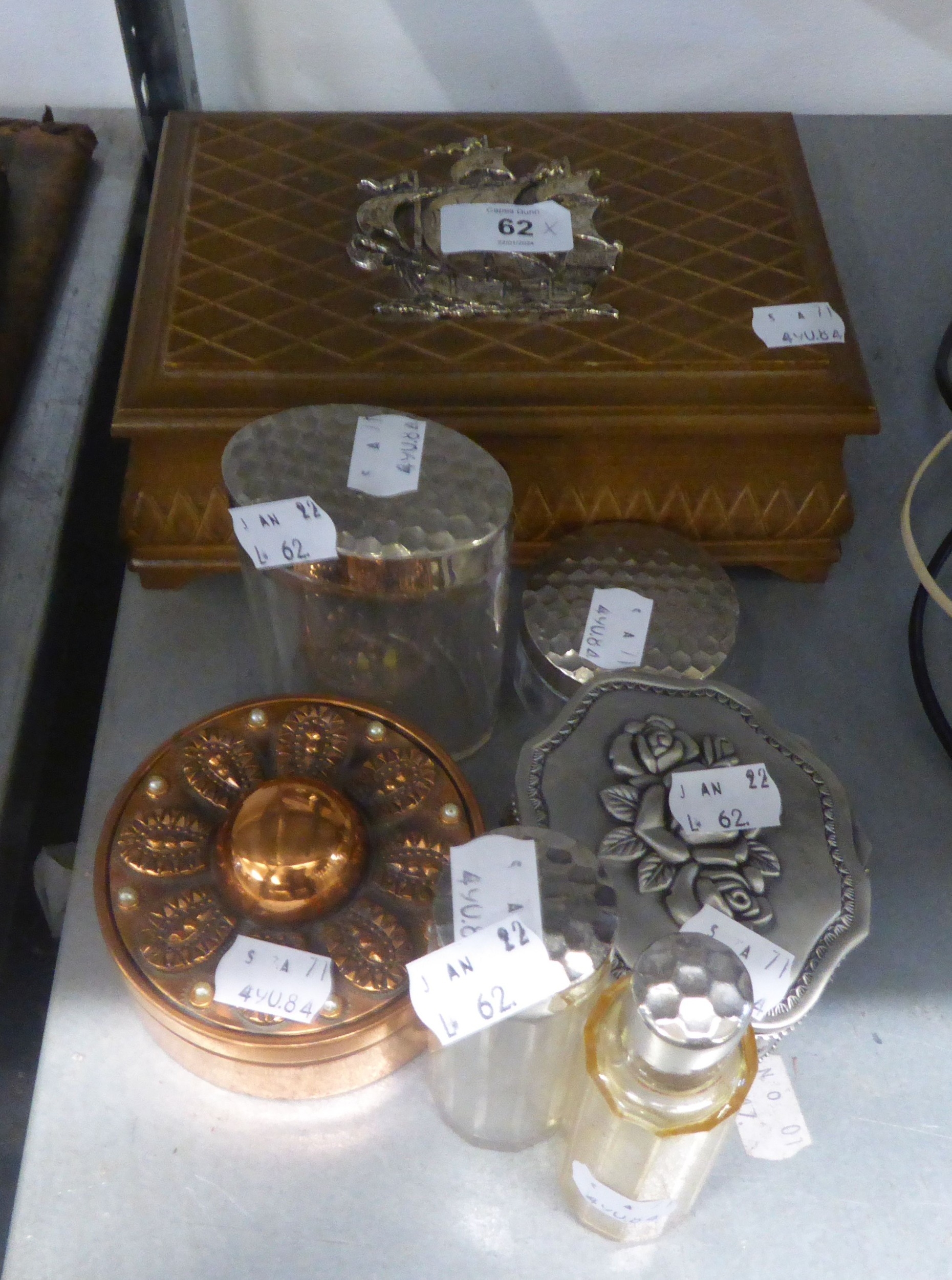 A WOODEN TABLE CIGARETTE BOX, WITH APPLIED METAL GALLEON DECORATION; AN EMBOSSED COPPER CIRCULAR