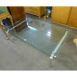 A LARGE OBLONG PLATE GLASS COFFEE TABLE, ON TWO BENT METAL END SUPPORTS, 4'7" X 2'8"