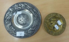 A CAST PEWTER CIRCULAR WALL PLAQUE, EMBOSSED WITH FIGURES AND ANIMALS, 7 ¾” DIAMETER AND A GILT