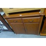 A CHERRYWOOD TWO DRAWER ABOVE TWO DOOR CHIFFONIER, HAVING SHAPED TOP