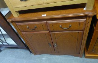 A CHERRYWOOD TWO DRAWER ABOVE TWO DOOR CHIFFONIER, HAVING SHAPED TOP