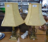 A PAIR OF METAL CANDLESTICK PATTERN POTTERY TABLE LAMPS AND SHADES