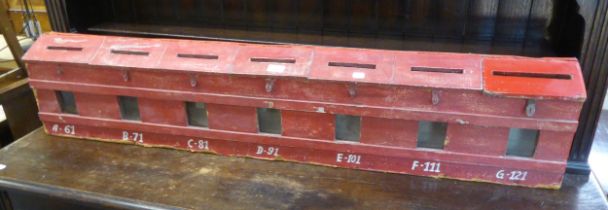A RED PAINTED LETTER HOLDER, HAVING SIX COMPARTMENTS