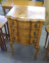 A 1930'S SERPENTINE THREE DRAWER NIGHTSTAND, ON CABRIOLE LEGS