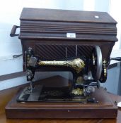 A MANUAL PORTABLE SEWING MACHINE IN WOODEN CASE