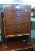 A PLAIN MAHOGANY MUSIC CABINET, WITH FIVE FALL FRONT DRAWERS