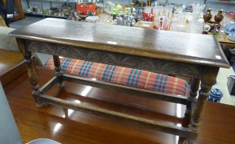 A JACOBEAN STYLE CARVED OAK FENDER STOOL, 3’ LONG