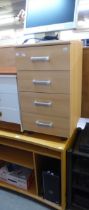 A BLONDE BEECH WOOD-EFFECT COMPUTER DESK AND MATCHING CHEST OF FOUR DRAWERS AND A HOME COMPUTER