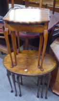 A NEST OF THREE WALNUTWOOD OVAL COFFEE TABLES (ONE LEG A.F.), AND A NEST OF TWO MAHOGANY COFFEE