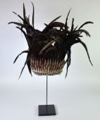 MODERN BLACK FEATHER AND SPLIT SHELL TRIBAL STYLE HEADDRESS, on stand, 29” (73.7cm) high overall