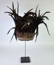 MODERN BLACK FEATHER AND SPLIT SHELL TRIBAL STYLE HEADDRESS, on stand, 29” (73.7cm) high overall