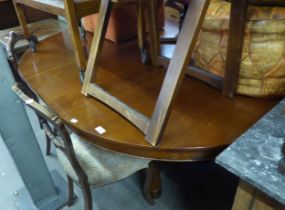 A MAHOGANY CIRCULAR DINING TABLE, ON HEXAGONAL COLUMN AND QUATREFOIL BASE WITH PULL-OUT ACTION FOR