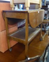 AN OAK OVAL TWO TIER PEMBROKE TEA TROLLEY, WITH END DRAWER