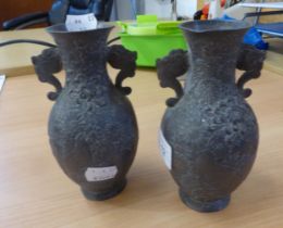 A PAIR OF METAL, SMALL TWO-HANDLED VASES, EMBOSSED WITH GROUSE AMONGST FLOWERING SHRUBS