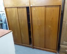 A PAIR OF TEAK FINISH WARDROBES, EACH WITH TWO SLIDING DOORS AND A TOP BOX WITH LIFT FRONT