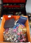 A JEWELLERY CASE CONTAINING A SILVER CHARM BRACELET AND A LARGE QUANTITY OF COSTUME JEWELLERY TO