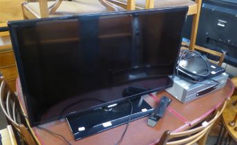 SAMSUNG FLAT SCREEN TELEVISION AND A DVD/VIDEO PLAYER