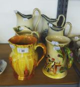 SMALL SELECTION OF JUGS THREE GRADUATED DEPICTING SCENES FROM JERSEY, A CROWN DEVON MUSICAL JUG (