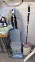 AN ORECK VACUUM CLEANER, A MIRCOTEX MOP AND BUCKET, A TUBULAR METAL IRONING BOARD AND AN ELECTRIC