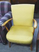 AN ERCOL OPEN ARMCHAIR, THE BACK AND SEAT COVERED IN YELLOW FABRIC