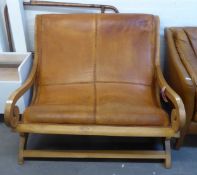 A TEAK FRAMED TWO SEATER PLANTATION STYLE SETTEE, COVERED IN BROWN LEATHER