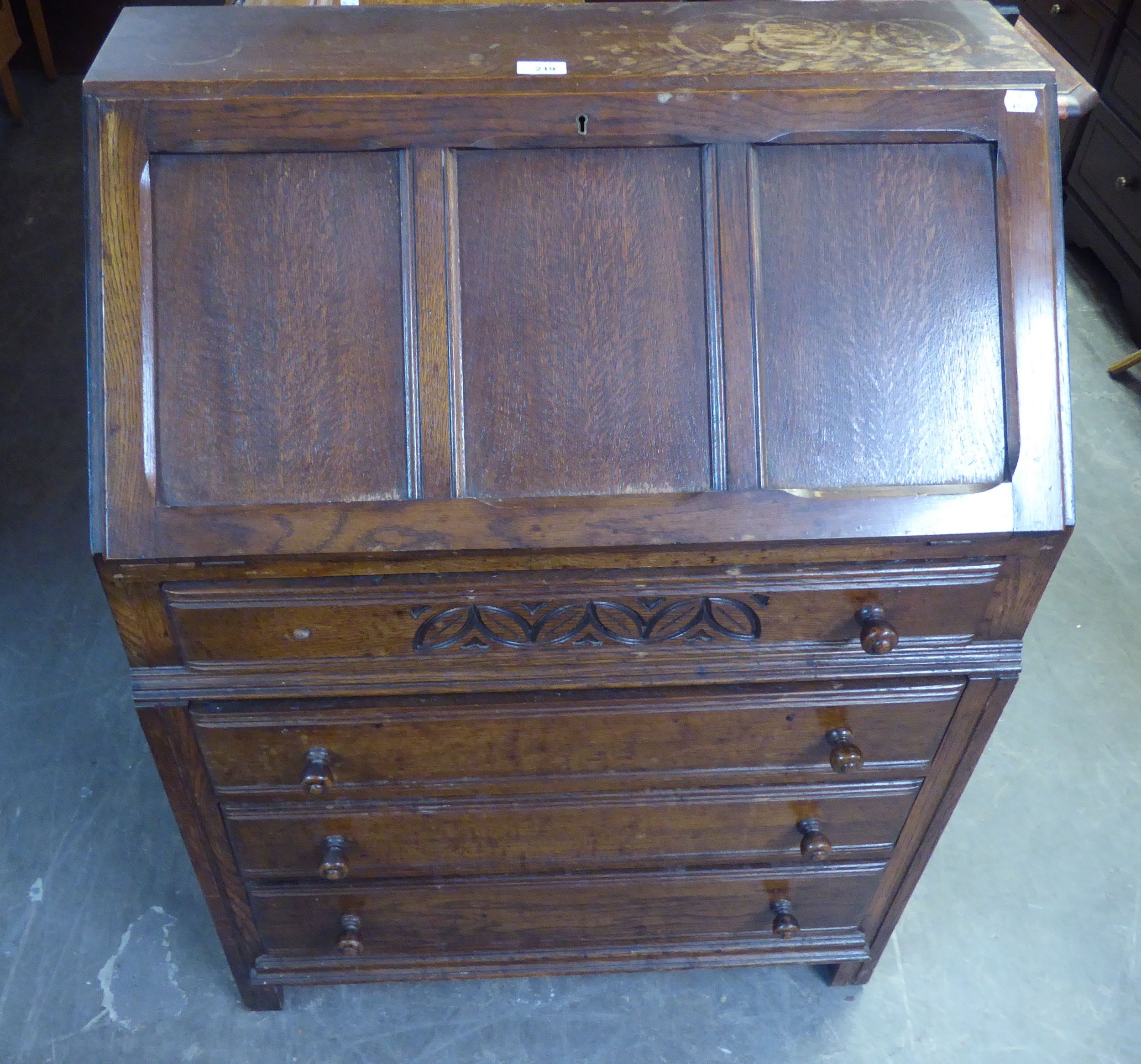 AN OAK BUREAU WITH FOUR LONG DRAWERS