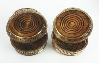 WINE COASTERS: Two pairs of silver plated wine coasters with stained beech bases [4]