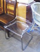 A MODERN TUBULAR METAL CANTILEVER SINGLE CHAIR WITH CLEAR PERSPEX BACK AND SEAT