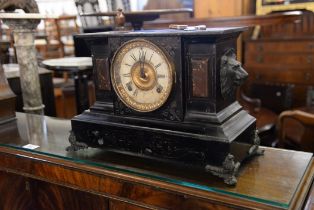 A LARGE ANSONIA, NEW YORK BLACK SLATE AND BRASS MANTEL CLOCK, HAVING LIONS HEAD CARRYING HANDLES