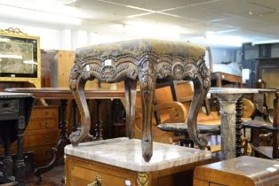 A POSSIBLY CONTINENTAL CARVED OAK CABRIOLE LEGGED DRESSING STOOL