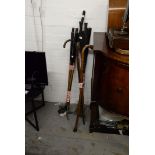 A SMALL SELECTION OF GOLF CLUBS. TOGETHER WITH THREE WOODEN WALKING STICKS