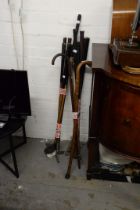 A SMALL SELECTION OF GOLF CLUBS. TOGETHER WITH THREE WOODEN WALKING STICKS