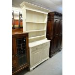 A PINE WHITE PAINTED DRESSER, HAVING TWO DRAWERS ABOVE TWO CUPBOARD DOORS WITH PLATE RACK ABOVE