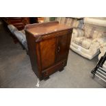 A SMALL OAK TALL-BOY HAVING TWO CUPBOARD DOORS OVER ONE LONG DRAWER