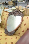A MAHOGANY FRAMED HEART SHAPED MIRROR, HAVING CARVED DECORATION OF LEAVES AND GRAPES