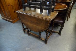 A VICTORIAN OAK DROP-LEAF DINING TABLE, RAISED ON SPIRAL SUPPORTS