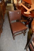 A SET OF FOUR PURITAN STYLE DINING CHAIRS, COVERED IN BROWN LEATHER WITH STUDDED DECORATION (4)