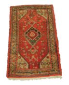 HAMADAN, PERSIAN RUG, with hexagonal centre medallion with pendants, on a crimson field with green