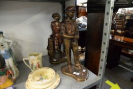 PAIR OF BRONZE EFFECT RESIN FIGURES OF GOLFERS, ON KIDNEY SHAPED BASES, 16 1/4" HIGH