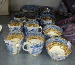 EIGHTEENTH CENTURY POWDER BLUE AND GILT TEA BOWLS, COFFEE CANS AND SAUCERS IN THE MANNER OF