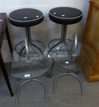 PAIR OF KITCHEN BAR STOOLS, CHROME FRAMED AND BLACK SEATS AND A PAIR OF GLASS COFFEE TABLES ON